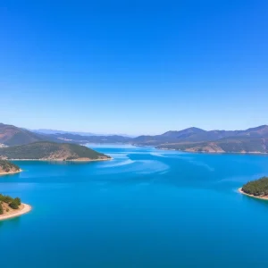 Aerial view of Lake Oroville at full capacity with lush surroundings