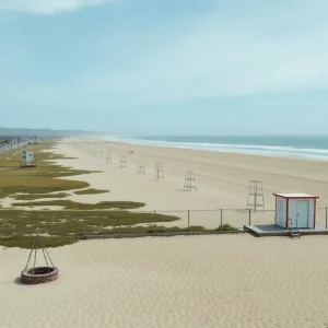 Closed public restrooms and empty fire pits on a San Diego beach