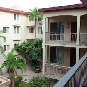 View of an apartment complex in San Ysidro with a third-floor balcony.