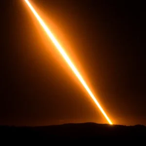 Bright streak in night sky depicting SpaceX Dragon spacecraft
