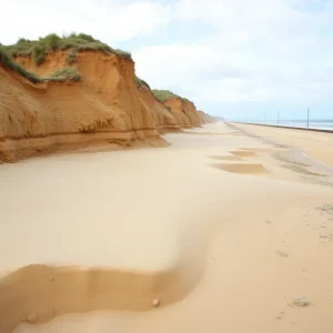 Erosion along the beach with train tracks in the background in San Clemente.