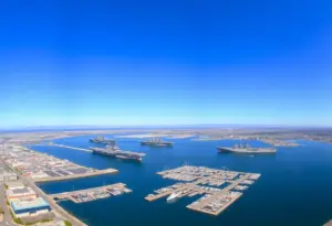 Panoramic view of San Diego naval harbor with ships and carriers