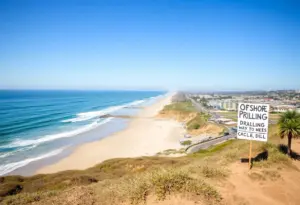 Beachfront community in Encinitas, with activism signs opposing offshore drilling.