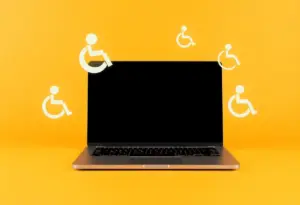 Visual representation of ADA website accessibility challenges with a laptop and accessibility symbols.