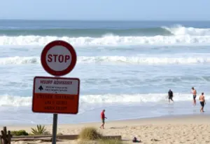 High surf waves crashing at a San Diego beach during an advisory
